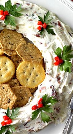 a white plate topped with crackers on top of a cake covered in whipped cream