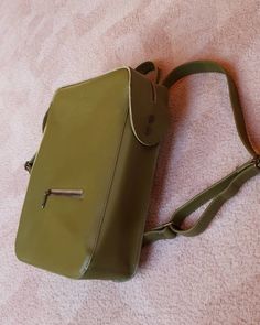 This moss colour genuine leather backpack is perfect accessory to your everyday city outfit. The colour is perfect for each season of the year.  It keeps it's strict form, so it can be perfect office backpack, where you can carry laptop, documents and all daily essentials here. #leatherbackpack #greenleatherbackpack #minimaliststyle #geometricbackpack #laptopbackpack Green Leather Rectangular Backpack, Green Rectangular Leather Backpack For Daily Use, Rectangular Green Leather Backpack For Daily Use, Leather Backpack With Adjustable Strap In Khaki, Green Leather Travel Backpack, Green Leather Laptop Backpack, Khaki Leather Backpack With Adjustable Strap, Khaki Leather Backpack, Modern Green Backpack