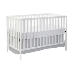 a white baby crib with no sheets on the bottom and side rails, in front of a white background