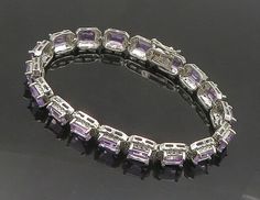 925 Sterling Silver - Prong Set Shiny Amethyst Hinge Chain Bracelet - BT7354  925 Sterling Silver - Prong Set Shiny Amethyst Hinge Chain Bracelet - BT7354  Jewelry Type:         Bracelet   Metal Type:            925 Silver  Metal Size:             7.5" Length  .25" Height   Stone Type:            Amethyst   Condition:              N/A  Jewelry Weight:     21.2 Grams  PLEASE NOTE: THIS ITEM IS PRE-OWNED. ALTHOUGH MOST ITEMS ARE IN VERY GOOD CONDITION, SOME MAY NEED CLEANING AND/OR MINOR REPAIRS. WE MAKE A VERY STRONG EFFORT TO UPLOAD CLEAR PICTURES. PLEASE INSPECT ALL PICTURES AND ASK ALL QUESTIONS YOU MAY HAVE PRIOR TO MAKING A PURCHASE. NOT ALL STONES ARE GENUINE, SOME ARE ENHANCED OR CREATED. Silver Gemstones With Jewels In Fine Jewelry Style, Elegant Silver Gemstones With Jewels, Luxury Rectangular Amethyst Jewelry, Purple Jewelry With Jubilee Bracelet For Anniversary, Luxury Purple Rectangular Jewelry, Elegant Sterling Silver Amethyst Bracelet, Elegant Sterling Silver Amethyst Bracelet For Formal Occasions, Anniversary Bracelet With Gemstone Accents, Formal Silver Amethyst Bracelet