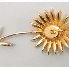 Goldtone prong set white cabochon and marquise rhinestone daisy brooch with security clasp. Marked "Napier" in tiny letters on the back of the stem. Circa 1964. Measures: 3 7/8 inches long by 1 5/8 inches wide. Excellent condition. The matching earrings with white and red rhinestones are shown on pg. 371 of Melinda L. Lewis & Henry Swen's book "The Napier Co.: Defining 20th Century American Costume Jewelry." American Costume, Chanel Flower, Bakelite Brooch, 1960 Jewelry, Van Cleef And Arpels, Daisy Earrings, Gold Brooches, White Rhinestone, Red Rhinestone