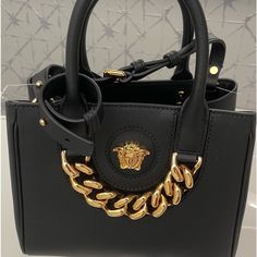 Brand New Beautiful Black Elegant Bag. You Can Wear As A Crossbody Or As A Tote Bag. I Have A Dust Bag. No Tag. Never Used. High-end Bags With Chain Strap And Top Handle, High-end Black Bags With Branded Hardware, Black Bag With Gold-tone Hardware For Everyday Luxury, Luxury Everyday Bags With Chain Strap, Luxury Bags With Chain Strap And Top Handle, Luxury Shoulder Bag With Chain Strap And Top Handle, Luxury Top Handle Bag With Chain Strap, Trendy Bags With Gold-tone Hardware For Everyday Luxury, Black Crossbody Shoulder Bag For Everyday Luxury