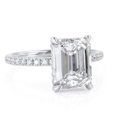 ✥ Step into elegance with our 2.50CT Emerald Cut Hidden Halo Moissanite Diamond Pave Engagement Ring. This exquisite ring features a dazzling 2.50 carat emerald-cut moissanite diamond accented by a delicate hidden halo of pave-set diamonds, enhancing its brilliance and allure. Meticulously crafted with precision, it blends classic sophistication with modern design, creating a timeless symbol of love and commitment. Perfect for those who cherish luxury and impeccable craftsmanship, this ring promises to capture hearts and commemorate your special moment with unmatched beauty and grace.✦ Main Stone Details✧ Shape: Emerald Cut Moissanite✧ Weight: 2.50CT (App. 9x7mm)✧ Color: DEF(Colorless)✧ Clarity: VVS ✦ Side Stone Details✧ Shape: Round Moissanite✧ Weight: 0.25CT✧ Color: DEF (Colorless)✧ Clar Emerald Cut Hidden Halo, Halo Moissanite Engagement Ring, Emerald Cut Moissanite, Hidden Halo, Moissanite Engagement, Moissanite Engagement Ring, Emerald Cut, Halo, Engagement Ring