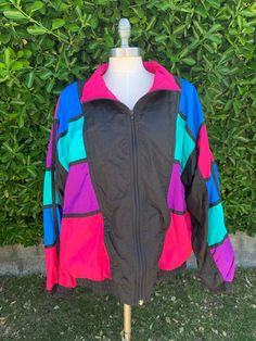 "Super fun, bright and colorful vintage circa 1980s-1990's bomber jacket. Picasso inspired nylon windbreaker. Bold statement piece to add to anyone's collection. Excellent vintage condition. Size: XL Length: 25\" Width: 25\" Sleeve: 21\" All approx measurements are taken laying flat. ✨Lighting in pictures may vary.✨ Please feel free to message with any questions before purchasing. All sales are final. No refunds or exchange are available.  Vintage sizes tend to run small, so please check measurements.  Unlike brand new merchandise, vintage and antique items will often show signs of wear and aging." Patchwork Nylon Windbreaker For Spring, Retro Multicolor Spring Windbreaker, 90s Multicolor Hooded Outerwear, Retro Multicolor Windbreaker For Streetwear, Retro Pink Windbreaker, 90s Inspired Multicolor Long Sleeve Outerwear, 90s Style Multicolor Windbreaker For Spring, 90s Multicolor Windbreaker For Outdoor, 90s Style Multicolor Windbreaker For Outdoor