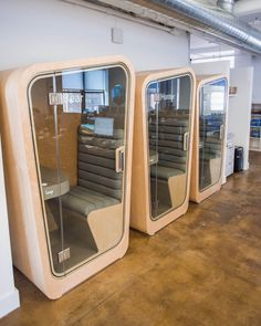 three large mirrors sitting next to each other in a room