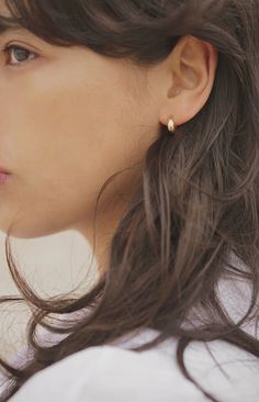 These solid cast hoop earrings feature an organically textured surface with a rugged, rough finish. The Lithic Earrings make a sleek, minimalist statement on their own or can be layered with other styles for a more personalized look. ✦ Measures 12mm in length ✦ 14K Gold over Sterling Silver / Made with recycled metals ✦ Handmade in the Santa Cruz mountains, USA Silver Ear Studs, Textured Hoop Earrings, Simple Dangling Earrings, Minimal Jewelry Earrings, Minimal Gold Earrings, Subtle Earrings, Minimalist Gold Earrings, Minimalistic Earrings, Minimalist Earring