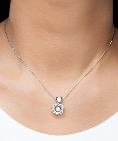 - Heart Knot Silver Necklace: Weight: 0.2 oz - The pendant is 0.75 inch (19mm) in length and 0.45 inch (11.5mm) in width. - Final product is hand polished in Miami Fl. and shipped fast to your door. - Our Alluring Luxury box will bring a touch of luxury to your jewelry. - Stunning .925 Sterling Silver necklace. - AAAA grade cubic zirconia jewels set throughout the necklace. - The chain length is 15.75 inches including a 1.97 inch extender. - The pendant can be removed from the chain. - Polished Heart Knot, Sterling Silver Heart Pendant, Golden Necklace, Silver Heart Pendant, Silver Heart Necklace, Mom Necklace, Son Gift, Exclusive Gift, Knot Necklace