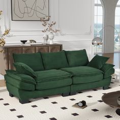 a green couch sitting in a living room on top of a white carpeted floor