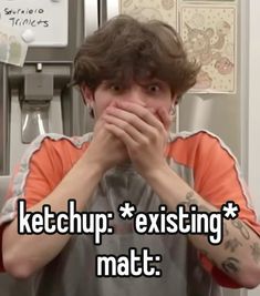 a man covering his mouth while standing in front of a refrigerator with the words ketchup existing mat