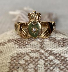 A traditional Claddagh ring with the lovely symbols of the HEART for love, the CROWN for loyalty and the clasped HANDS for friendship. This traditional Irish ring is part of the 'Fede Rings' ('Hands in Faith') dating from Ancient Rome and popular during the Middle Ages and Renaissance as engagement and wedding rings. This particular example sparkles with with the star set white stone in the center of the heart. - Size: US 11 1/4; UK W 1/2; France 65,5; Numero 25.5 (large size) - Weight: 2.73 gr Claddagh Wedding Bands, Clasped Hands, Irish Ring, Claddagh Ring Wedding, Irish Ring Claddagh, Irish Rings, Engagement And Wedding Rings, Rome Antique, Claddagh Ring