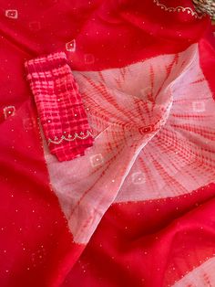 Aalna exclusive- a 100% pure organza completely hand dyed in the prettiest baby pink shade with tie-dye bandhej and shibori craft. The bandhej is done in the body and the shibori is in the palla. Both are done completely by hand. It is NOT a print. The combination of bright red and cream is stunning. After the dyeing, intricate scallop border and beautiful embroidery is done in the border as well as in the body in the bandhej butas. Micro size mirror is also hand stitched throughout the saree. I Red Bandhani Print Dupatta For Party, Fitted Organza Saree For Summer, Summer Fitted Organza Saree, Silk Bandhani Print Dupatta For Party, Pink Organza Dupatta For Transitional Season, Red Organza Dupatta For Transitional Season, Traditional Red Dupatta For Summer, Traditional Red Summer Dupatta, Summer Bollywood Red Dupatta