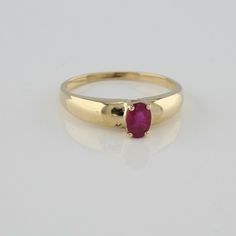 10K Yellow Gold 1/2ct + Ruby Ring, oval 5.8 x 4mm faceted red stone dome top, Ring size 7 3/4, Circa 1960, 1.94 grams SKU# BB280R07 This listing contains photographs of the actual item you will receive. Our items are in excellent condition with little or no signs of wear and many are one of a kind pre-owned estate finds. Please look closely at the pictures in this listing as they are part of the product description. Please read the description, as any imperfections or condition comments will be Yellow Gold Ruby Ring With Oval Cabochon, Classic Yellow Gold Ruby Cabochon Ring, Gold Ruby Ring With Bezel Setting, Oval Cabochon, 14k Gold Polished Oval Cabochon Ruby Ring, Handmade Yellow Gold Ruby Ring, Fine Jewelry, Red Band, Ring Oval, Fine Jewelry Designers, Red Stone