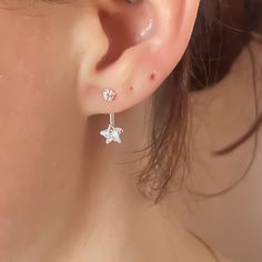 These sterling silver cubic zirconia ear jackets are sure to make you feel like a shining star! With their dreamy star charms adorned with dainty round stones, these earrings are both stunning and eye-catching. Everyone will be asking where you got them. * 𝗠𝗔𝗧𝗘𝗥𝗜𝗔𝗟𝗦 *  * 925 Sterling Silver * 6x20mm   * 𝗣𝗔𝗖𝗞𝗔𝗚𝗜𝗡𝗚 *  * Orders are shipped in recyclable boxes  * We package our pieces in small recyclable bags for secure and safe shipping  * Every order comes with 1 velvet jewelry bag to store items in after opening    * 𝗢𝗥𝗗𝗘𝗥 𝗧𝗜𝗠𝗘𝗦 *  * Orders are shipped out Same or Next Day    * 𝗦𝗛𝗜𝗣𝗣𝗜𝗡𝗚 *  𝑪𝑨𝑵𝑨𝑫𝑨  * FREE Regular Mail Shipping for all orders (NOT tracked)  * FREE Tracked Shipping for orders of $120+  * 2-8 Business Days Arrival Time  ➤ If you would l Star-shaped Sterling Silver Piercings, Packaging Orders, Earrings Aesthetic, Stud Earrings Silver, Ear Jacket Earring, Recycle Bag, Velvet Jewelry, Ear Jacket, Shining Star