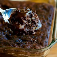 a spoonful of chocolate cake in a glass dish