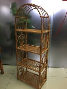 a bamboo birdcage sitting on top of a white floor next to a chair