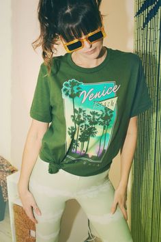 venice beach graphic tee 80s graphic t shirt vintage style shirt eighties shirt 80s beach tee california t shirt retro venice beach tee Size Guide: Our 100% cotton Venice Beach tee comes in a Unisex style on Green. Please refer to the provided tee measurements given in the listing images. It is advisable to compare these with the measurements of your favorite tee when making your size selection. Please note our tees are not women's fitted.     Details: ☆ Unisex style ☆ 100% cotton ☆ Crew neck ☆ Summer Graphic Print T-shirt For Streetwear, Summer Streetwear Tops With Screen Print, Summer Streetwear Graphic Print T-shirt, Green 90s Style T-shirt For Summer, Retro Summer T-shirt With Front Print, Summer Graphic Design Crew Neck T-shirt, Vsco Style Letter Print T-shirt For Streetwear, Summer Tops With Graphic Design In Relaxed Fit, Relaxed Fit Summer Tops With Graphic Design