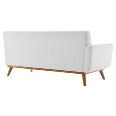 a white couch sitting on top of a wooden frame