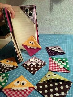 an open book on a table with paper cut out to look like owls and polka dots