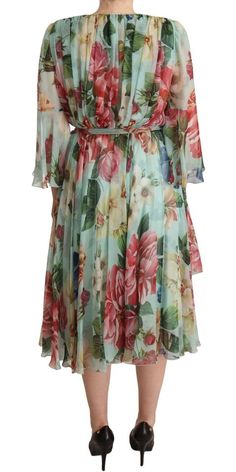 Elevate your wardrobe with this stunning Floral Silk Midi Wrap Dress by Dolce & Gabbana. Gorgeous and brand new with tags, this 100% authentic dress exudes elegance with its luxurious silk fabric and vivid, colorful floral print. Perfect for any occasion, it features a flattering belted waist and a sophisticated midi length, ensuring a silhouette that captures the essence of femininity. Crafted with exceptional care in Italy, this piece isn’t just a dress – it’s a statement of style and quality.