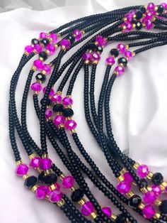 "Maasina" 🌟, a single-strand waist bead that beautifully merges tradition and contemporary allure. Crafted with love and skill, Maasina is more than a bead; it's a journey, a celebration of strength, femininity, and cultural richness. ✨ Black Seed Beads: Symbolize strength, individuality, and timeless elegance. Embrace the depth of your uniqueness with the empowering shade. 💖 Fuchsia Crystal Accents: Add a pop of vibrancy and femininity to your style. Infuse energy and passion into every step you take. 🌟 Gold Glass Seed Beads: Elevate your look with subtle brilliance and sophistication. Symbolize prosperity, creating a link to cultural heritage. Maasina isn't just a waist bead; it's a tapestry of your story, handwoven with cultural threads. The single-strand design ensures comfort and s Black Waist Beads, Waist Jewelry, Strong Hand, Waist Beads, Dreadlock Hairstyles, Every Step You Take, Black Seed, Hairstyles Black, Glass Seed Beads