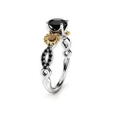 a black and white diamond ring with gold accents