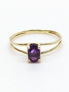 Add a touch of elegance to your outfit with this stunning 14K Yellow Gold Amethyst Lady's Ring. Weighing 1.2g, this dainty ring features a simple split shank design that exudes sophistication. The beautiful amethyst stone adds a pop of color, making it a perfect accessory for any occasion. Available in size 5.75, this ring is sure to become a beloved piece in your jewelry collection. The shank measures 1.5mm at its thinnest. The ring sits 5mm on top of the finger. The amethyst measures 6.2mm by 14k Gold Amethyst Solitaire Ring, Dainty Amethyst Ring For Formal Occasions, Classic 14k Gold Amethyst Birthstone Ring, Dainty Amethyst Gemstone Ring For Formal Occasions, Formal Yellow Gold Amethyst Birthstone Ring, Elegant Oval Amethyst Stackable Ring, Classic 14k Yellow Gold Amethyst Ring, 14k Yellow Gold Stackable Amethyst Ring, Yellow Gold 14k Stamped Amethyst Ring