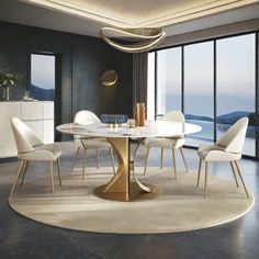 a dining room table with white chairs and a large window overlooking the ocean in front of it