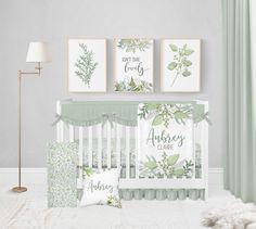 a baby's room with green and white decor, including a crib bed