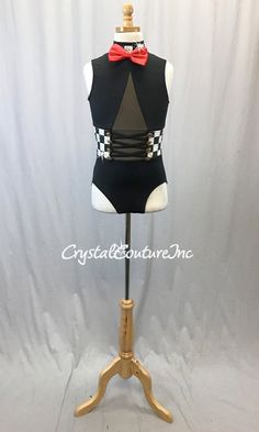 Black lycra tuxedo inspired leotard with Black & White checkered print mock-neck and cumber band. Costume had deep v mesh front inset lined with Nude, strappy midriff and upper back. Accented with Red bow, Gold buttons and Swarovski rhinestones Almost 2 gross Swarovski Jete Hematite 20ss and Crystal 20ss rhinestones! Summer Black Fitted Unitard, Fitted Black Summer Unitard, Fitted Black Unitard For Summer, Summer Fitted Black Unitard, Fitted Black Leotard For Party, Black Fitted Dance Leotard, Fitted Black Dance Leotard, Fitted Black Dancewear Leotard, Fitted Black Leotard For Night Out