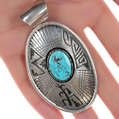 Large Marita Benally Navajo Sterling and turquoise pendant 3 1/8" tall with bail
x 1.75" wide, 47.8 grams. Marita Benally was born and raised in Steamboat, AZ,
and she is from the Navajo tribe.Marita started silversmithing in the late 90's,
and she credits her husband, Daniel Benally for teaching her to design and work
silver.She loves to create detailed, articulate designs. Today, Marita works out
of Gallup, New MexicoAll precious metals are tested and guaranteed, any Native
American jewelry re Southwestern Engraved Turquoise Necklace, Collectible Southwestern Turquoise Pendant Necklace, Engraved Southwestern Turquoise Necklace, Southwestern Turquoise Pendant Necklace, Southwestern Style Turquoise Pendant Necklace, Southwestern Style Turquoise Round Pendant Necklace, Southwestern Turquoise Necklace With Large Round Pendant, Navajo Tribe, Silver Gift Wrap