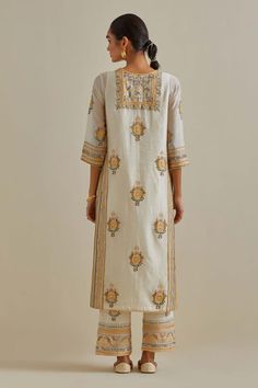 Yellow and off-white cotton chanderi straight kurta with side pockets and silk thread, mirror, sequins, tassels and braids embroidered patchwork. Comes with cotton straight pant, a dupatta and a slip. - Aza Fashions Cotton Straight Kurta With Motifs, White Chanderi Kurta With Block Print, Traditional White Block Print Kurta, Anarkali Cotton Kurta With Motifs, Anarkali Cotton Kurta In Cream, Cream Cotton Anarkali Kurta, Cream Anarkali Cotton Kurta, White Cotton Sets With Motifs, White Cotton Dupatta With Motifs