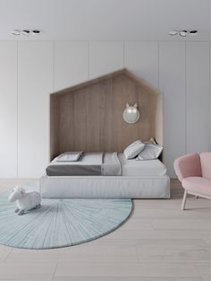 a bedroom with a bed, chair and rug on the floor