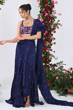 Midnight blue attached cancan ruffed lehenga saree with all over crystal drops embellishments and an attached drape. Paired with a backless halter neck padded blouse with multi colored sequins bloom embroidery. - Aza Fashions Designer Wear Lehenga With Traditional Drape For Summer, Fitted Lehenga For Designer Summer Wear, Summer Designer Wear Fitted Lehenga, Summer Reception Sharara With Unstitched Blouse, Traditional Drape Sharara For Summer Reception, Summer Reception Sharara With Traditional Drape, Silk Lehenga With Traditional Drape For Summer, Designer Wear Summer Sharara With Traditional Drape, Traditional Silk Lehenga For Summer