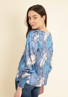 Introducing our Abigail Saddlery Print Blouse, where timeless equestrian elegance meets modern versatility. Featuring a classic silhouette, this blouse is designed to let the intricate Saddlery Print take center stage. With elasticated cuffs, flattering sleeves, and a scoop neckline, it effortlessly combines comfort with style. Perfect for pre-fall, this blouse shines in a classic color palette, making it an ideal pairing with white denim, jeans, or shorts. Embrace the understated beauty of eque Luxury Blue Formal Blouse, Luxury Blue Blouse For Formal Occasions, Blue Blouse With Blouson Sleeves For Work, Classic Color Palette, Equestrian Riding, White Denim Jeans, Equestrian Style, Tunic Blouse, Classic Silhouette