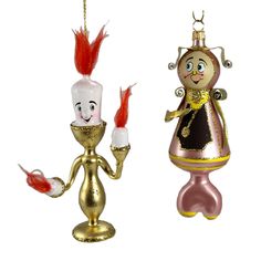 two christmas ornaments hanging from chains on a white background, one is gold and the other is pink