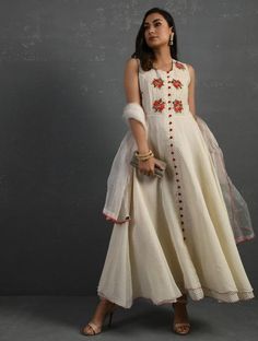 A double-layered umbrella cut front open Chanderi kurta with all-over floral buttis in yoke made using beads, sequins and silk French knots. Beadwork runs along the neckline and armhole. Contrast buttons and scalloped edges embroidered double layered flared hemline. The kurta comes with a delicate chanderi dupatta with all over sequence work and a wide woven zari border at the hem. Kurta measurements (in Inches): Size S: Bust - 38", Waist - 35", Length: 52" Size M: Bust - 40", Waist - 37", Lengt Sleeveless Kurta, Chanderi Dupatta, Chanderi Kurta, Accessories Online Shop, Sequence Work, Dupatta Set, French Knots, Sewing Design, Scalloped Edges