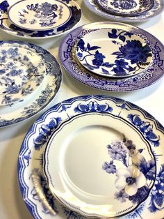 blue and white plates are arranged on a table