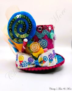 a colorful hat with buttons and beads on it's side, sitting on a white surface