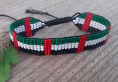 Loom beaded bracelet with United Arab Emirates, Fujairah Emirate flag. Patriotic hand woven beaded wristbandt is a great gift for a women, girl or child for birthday, Christmas, Valentine's Day and other holidays. Small frienship gift whis Middle East country flag. Is suitable for daily wear. Bracelet in stock and ready to ship. More bracelets here: https://www.etsy.com/shop/BeadSeeShop?ref=seller-platform-mcnav&section_id=30144819 The bracelet is made of Czech seed beads and strong nylon thread Duy Beni Bracelet, Multicolor Beaded Bracelets As Independence Day Gifts, Multicolor Beaded Bracelets For Independence Day Gift, Uae Flag Day Ideas, United Arab Emirates Flag, Emirates Flag, Flag Beads, Flag Bracelet, Bff Hands Aesthetic