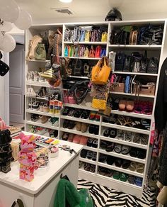 a room filled with lots of shoes and handbags on shelves next to each other