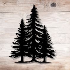 a cutout of two pine trees on a wooden background