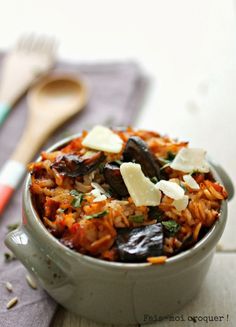 a bowl filled with rice and vegetables on top of a table