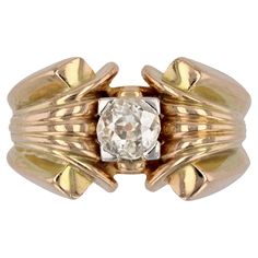 Ring in 18 karat yellow gold. Massive tank ring, its ring is openworked on the side then decorated with a fan-shaped pattern on both sides. In the center an antique brilliant- cut diamond is set with claws of platinum. Total weight of the diamond : about 0.70 carat. Height : 13.6 mm approximately, thickness : 5.3 mm approximately, width of the ring at the base : 6 mm approximately. Total weight of the jewel : 13,7 g approximately. US Size : 9,5 ; Free resize, please contact us. Authentic antique jewelry - Work of the 1940s. Our opinion : a beautiful model of diamond tank ring which can correspond to a man or a woman. Specialized in antique and creation jewelry since 1975, we deliver all our jewel with their certificate of authenticity, written by our certified antique jewelry expert and gr Tank Ring, Signet Ring, Brilliant Cut Diamond, Antique Jewelry, A Man, Platinum, Jewelry Rings, Gems, Yellow Gold