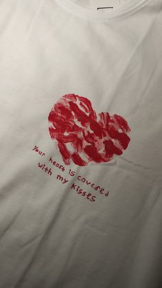 a white t - shirt with red writing on it that says, your heart is covered with my music