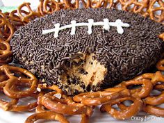 a chocolate covered football and pretzels on a plate