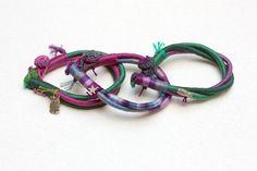 Friendship bracelet fiber art jewelry wrapped with metal Handmade Green Wrap Bracelet For Friendship, Green Handmade Wrap Bracelet For Friendship, Handmade Purple Wrap Bracelet As Gift, Handmade Green Braided Hippie Bracelets, Handmade Green Wrap Bangle Bracelet, Handmade Green Hippie Braided Bracelets, Handmade Bohemian Purple Wrap Bracelet, Purple Handmade Bohemian Wrap Bracelet, Green Bohemian Braided Bangle Bracelet