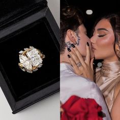 two women kissing each other in front of a black box and an image of a diamond ring