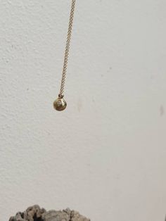 This is a 14 karat solid gold ball pendant necklace. It is a minimalist gold ball. solid gold pendant A 14 karat solid gold ball dangles on a 14 karat solid gold chain. It's a small, concentrated pendant with high density. This listing is for one 14 karat gold pendant on a 42 cm, 14 karat gold chain. ITEM DETAILS: Handmade item The length of the necklace is 42 cm. Materials:14 k solid gold Ball diameter: approx. 7 mm Pendant total length (including the bail): approx.8 mm. Ball pendant weight: ap Minimalist Polished Brass Necklaces, Minimalist Gold Plated Ball Chain Jewelry, Minimalist Jewelry With Ball Chain And Round Pendant, Minimalist Jewelry With Round Pendant Ball Chain, Minimalist Round Ball Chain Jewelry, Minimalist Yellow Gold Ball Chain Jewelry, Minimalist Gold Necklace With Ball Chain, 14k Gold Necklace With Ball Chain, Tarnish Resistant Yellow Gold Sphere Jewelry