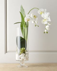 a vase filled with white flowers on top of a table