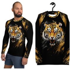 Don't let sunburn, wind, sand, or other elements ruin your day! This Men's Smooth & Versatile Rash Guard Activewear Shirt with a Unique Tiger Design will protect you while you have fun doing sports. It is slim-fitted with flat ergonomic seams, and a bit longer than your casual tee for extra comfort and protection. * 82% polyester, 18% spandex * Very soft four-way stretch fabric that stretches and recovers on the cross and lengthwise grains * UPF 50+ * Comfortable longer body and sleeves * Flat s Casual Crew Neck Rash Guard For Water Sports, Moisture-wicking Crew Neck Top For Water Sports, Long Sleeve Sports Shirt For Summer, Long Sleeve Shirt For Summer Sports, Graphic Print Crew Neck Top For Water Sports, Crew Neck Top With Graphic Print For Water Sports, Weightlifting Shirts, Unique Beach, Tiger Design